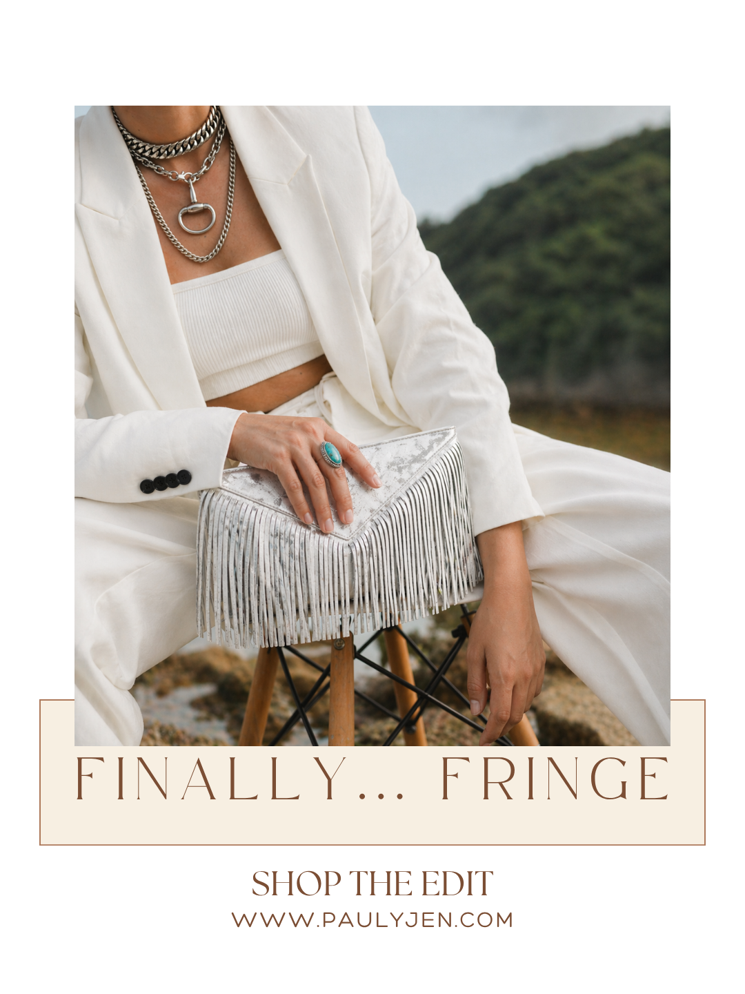 Woman in white blazer holding a white fringe clutch bag outdoors — PaulyJen fringe bag edit